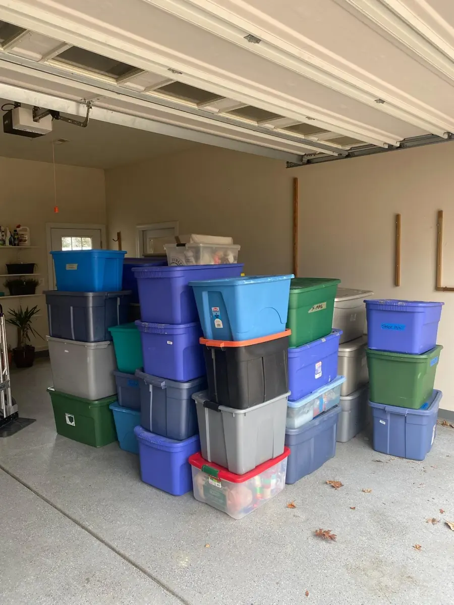 Storage bins stacked in a garage, ready for an M.C. Movers house move