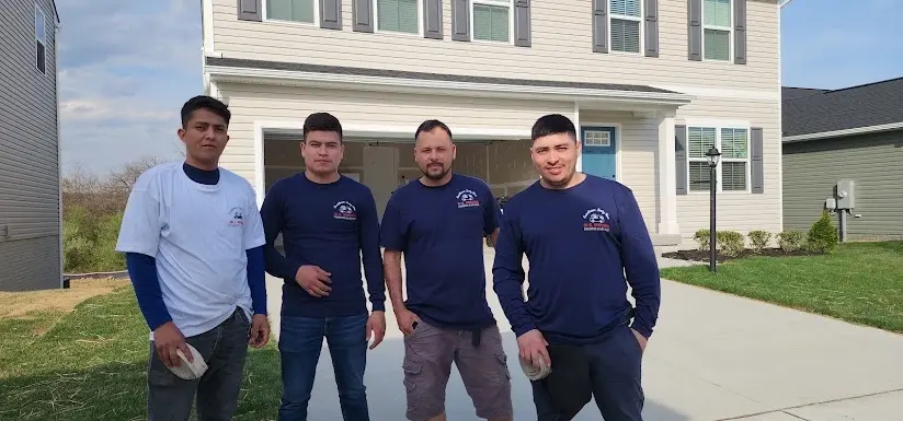 The M.C. Movers moving crew in branded shirts outside a new home in Northern Virginia