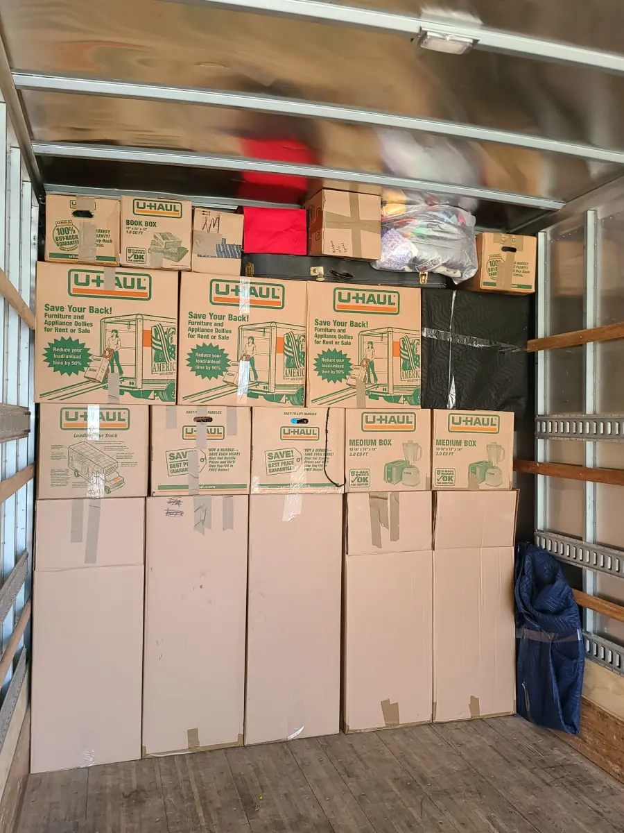 Moving truck tightly loaded with packed boxes by the M.C. Movers crew
